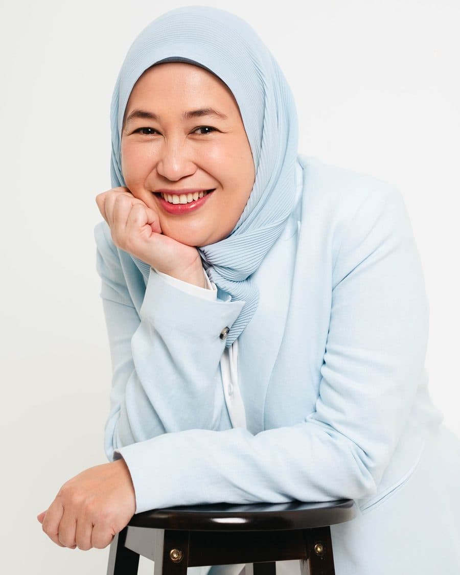 A founder portrait photographed against a clean studio backdrop