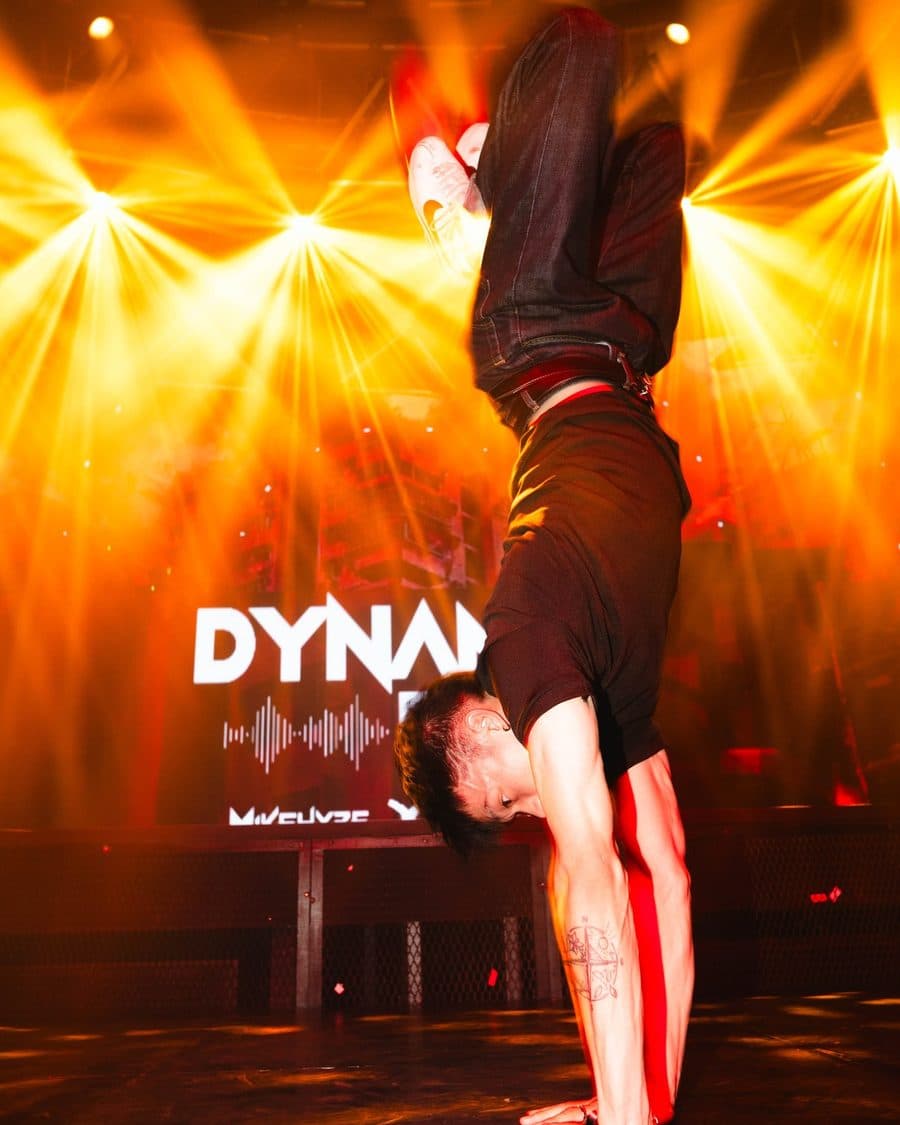 A performer mid-air under stage lights at a Malaysian live event