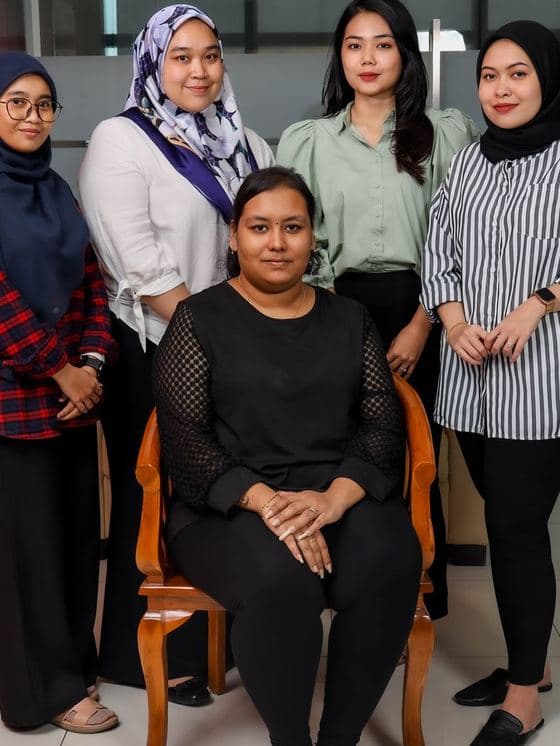A team portrait photographed in a Malaysian office